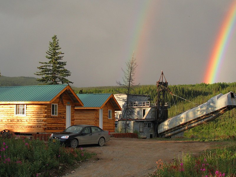 A double rainbow behind the cabins and gold dredge at Chicken, Alaska